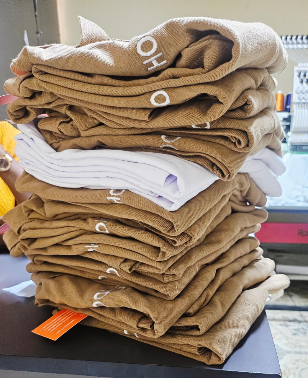 Folded stack of embroidered corporate polo shirts